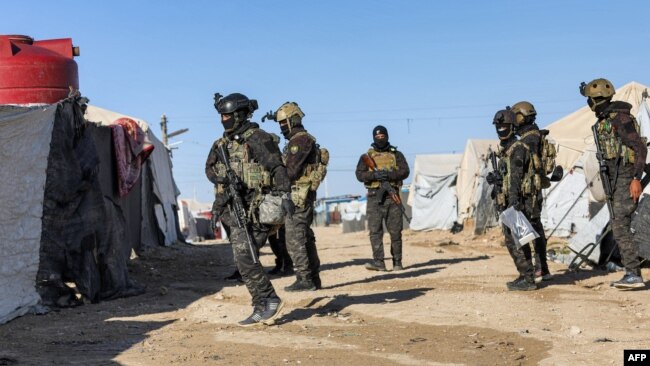 FILE: An image obtained from the media office of the Kurdish People's Protection Units in Syria (YPG) March 29, 2021 shows YPG forces conducting a security operation the previous day at the Kurdish-run al-Hol camp.