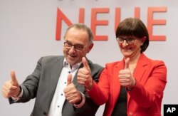 Norbert Walter-Borjans and Saskia Esken celebrate after their election to SPD chairpersons at the Social Democratic Party convention in Berlin, Germany, Dec. 6, 2019.