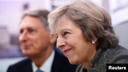 Prime Minister Theresa May and Chancellor of the Exchequer Philip Hammond during a visit to a construction site in Birmingham, where new HSBC offices are being built, Britain, Oct. 3, 2016. 