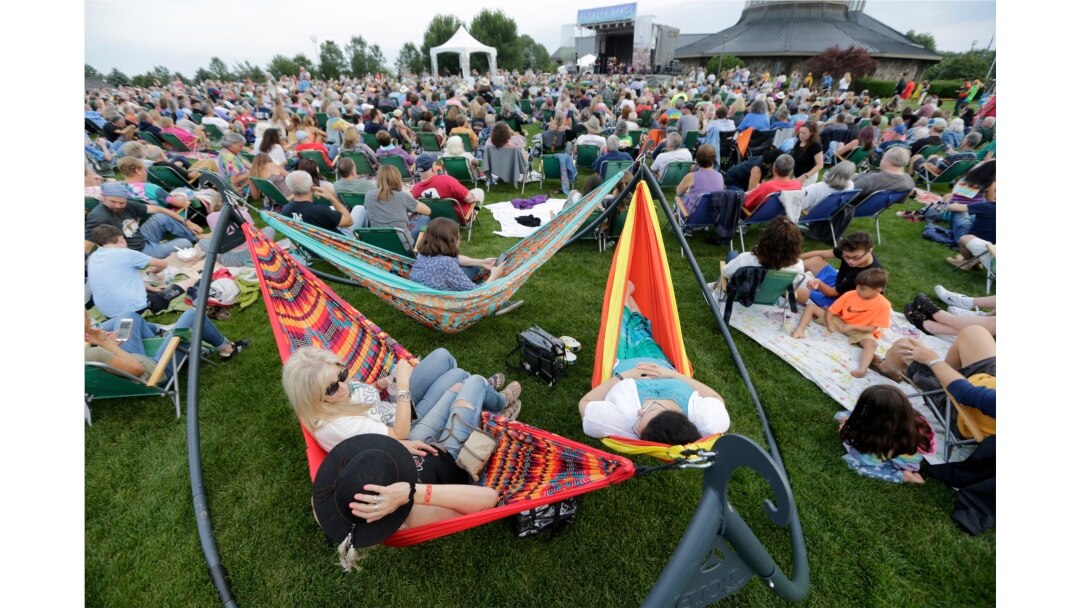 People enjoy a concert by Arlo Guthrie at a Woodstock 50th anniversary event in Bethel, N.Y., Aug. 15, 2019.