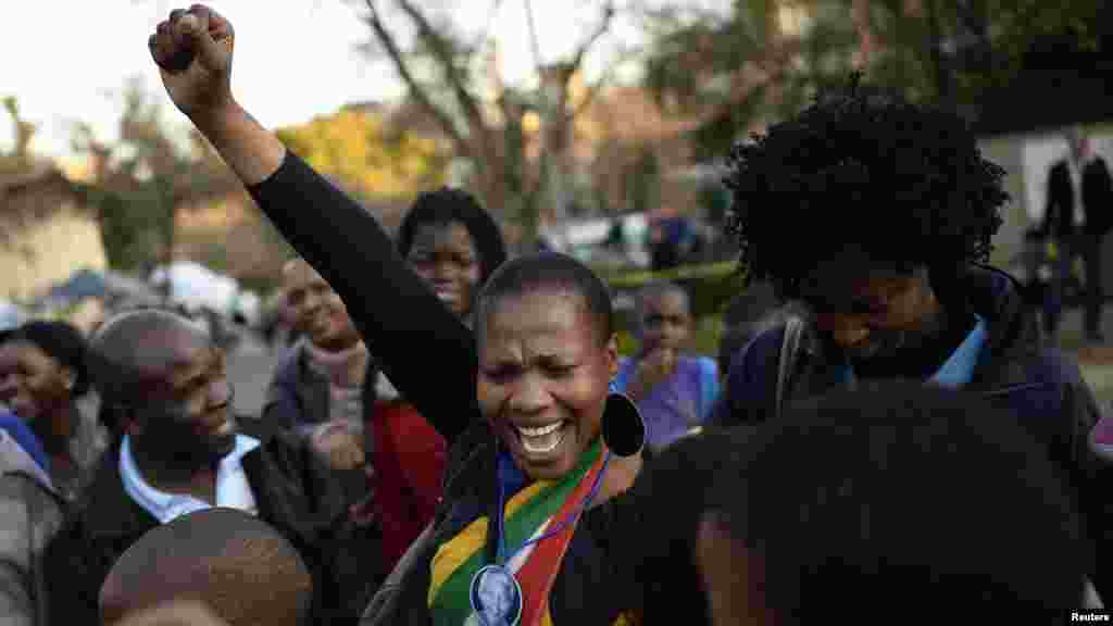 Youths pay respect to ailing former South African President Mandela.