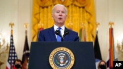 President Joe Biden speaks during an event to mark International Women's Day, in the East Room of the White House, March 8, 2021.