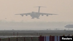 A U.S. Air Force aircraft carrying COVID-19 relief supplies from the U.S. prepares to land at the Indira Gandhi International Airport's cargo terminal in New Delhi, India, April 30, 2021.
