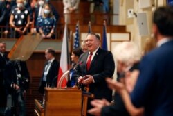 U.S. Secretary of State Mike Pompeo, center, smiles as he arrives for a meeting of the senate in Prague, Czech Republic, Aug. 12, 2020.