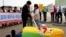 FILE - South Korean civic group members perform during rally against imported genetically modified organism (GMO) corn from China, Ulsan, South Korea, May 1, 2008.