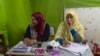 Workers at a polling station in Cairo have coffee while waiting for voters to show up, March 27, 2018. 