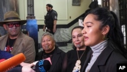 Hana-Rawhiti Maipi-Clarke, right, and her colleagues from Te Pāti Māori, talk to reporters following a protest inside Parliament in Wellington, New Zealand, Nov. 14, 2024.