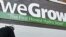 Workers put the finishing touches on the side of a building that will house a weGrow store in preparation for its opening on April 6, in northeast Washington, DC, March 29, 2012.