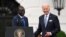 US President Joe Biden (R) and Kenyan President William Ruto (L) smile during an official arrival ceremony on the South Lawn of the White House in Washington, DC, on May 23, 2024.