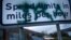 A sign on the border between Northern Ireland and the Republic of Ireland, spray painted with the initials of the Irish Republican Army, alerts drivers to the change in miles per hour for speed limit postings, Dec. 17, 2019, in Newry, Northern Ir
