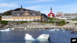 FILE - Small pieces of ice float in the water off the shore in Nuuk, Greenland, June 13, 2019. U.S. President-elect Donald Trump has said that acquiring Greenland, a sovereign Danish territory, is vital for U.S. security.