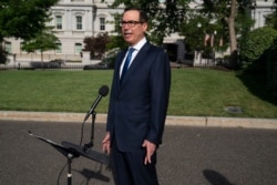 Treasury Secretary Steven Mnuchin speaks with reporters at the White House, July 23, 2020, in Washington.