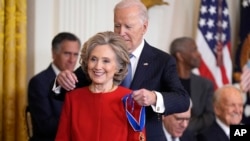 President Joe Biden, right, presents the Presidential Medal of Freedom, the nation's highest civilian honor, to former Secretary of State Hillary Clinton at the White House in Washington, Jan. 4, 2025.