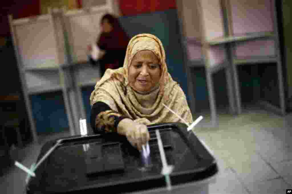 An Egyptian woman casts her vote inside a polling station in Cairo, Egypt, Thursday, May 24, 2012. In a wide-open race that will define the nation's future political course, Egyptians voted Thursday on the second day of a landmark presidential election th