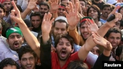 Supporters of the political party Pakistan Tehreek-e- Insaf (PTI) shout slogans during a rally in Lahore, March 23, 2013. 