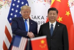 President Donald Trump, left, shakes hands with Chinese President Xi Jinping during a meeting on the sidelines of the G-20 summit in Osaka, Japan, June 29, 2019.