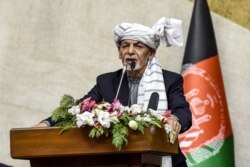 FILE - Afghanistan's President Ashraf Ghani speaks at the Parliament in Kabul, Oct. 21, 2020.