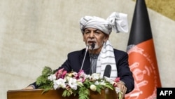 FILE - Afghanistan's President Ashraf Ghani speaks at the Parliament in Kabul, Oct. 21, 2020. 