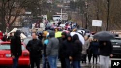 Local Serbs block the road near the village of Rudare, north of Serb-dominated part of ethnically divided town of Mitrovica, Kosovo, Dec. 11, 2022. 