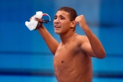 Ahmed Hafnaoui, of Tunisia, celebrates after winning the final of the men's 400-meter freestyle at the 2020 Summer Olympics, July 25, 2021, in Tokyo, Japan.