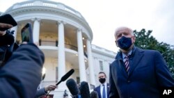 President Joe Biden talks to reporters on the South Lawn of the White House before boarding Marine One in Washington, Feb. 16, 2021. Biden is traveling to Milwaukee to participate in a town hall event. 