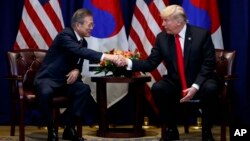 President Donald Trump shakes hands with South Korean President Moon Jae-In at the Lotte New York Palace hotel during the United Nations General Assembly, Sept. 24, 2018, in New York.