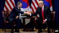 FILE - President Donald Trump shakes hands with South Korean President Moon Jae-In at the Lotte New York Palace hotel during the United Nations General Assembly, Sept. 24, 2018, in New York.