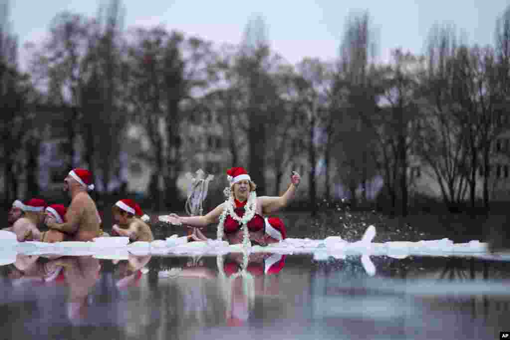 Members of the ice swimming club Berlin Seals attend the annual Christmas swimming at the partial frozen Oranke Lake in Berlin, Germany, December 25, 2012.