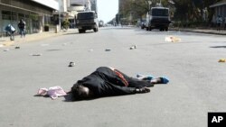 FILE: A woman lies in the road after been injured by police during protests in Harare, Friday, Aug, 16, 2019. This is the woman Doubt Asima tried to help.