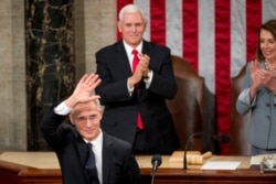 FILE - Vice President Mike Pence, center, applauds after NATO Secretary General Jens Stoltenberg, left, addressed a Joint Meeting of Congress on Capitol Hill in Washington, April 3, 2019.