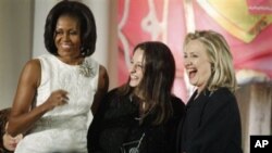 Secretary of State Hillary Rodham Clinton and first lady Michelle Obama present the 2012 International Women of Courage Award to Safak Pavey of Turkey, on the 101st Anniversary of International Women's Day, Thursday, March 8, 2012, at the State Department