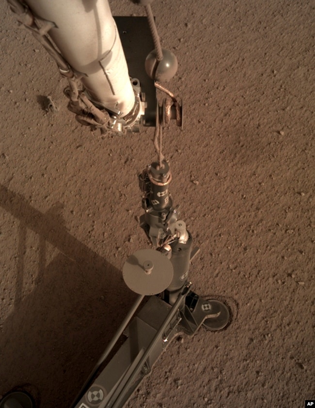 FILE - This photo provided by NASA/JPL-Caltech shows an image acquired by NASA's InSight Mars lander using its robotic arm-mounted, Instrument Deployment Camera (IDC). (NASA/JPL-Caltech via AP)