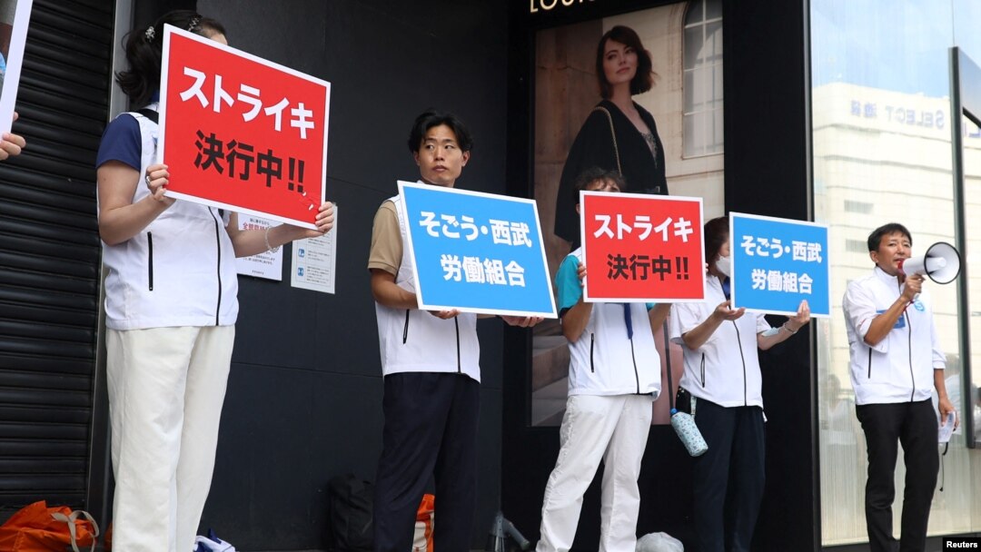 Serikat pekerja di Sogo & Seibu memegang spanduk bertuliskan 'mogok kerja' di depan toko utama perusahaan tersebut "Seibu Ikebukuro" di Tokyo, Kamis (31/8). 