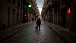 A man walks along an empty street in downtown Barcelona, Spain