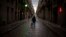 A man walks along an empty street in downtown Barcelona, Spain, March 26, 2020 as the lockdown to combat the spread of coronavirus continues. 
