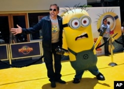 FILE - Steve Carell, a cast member in "Despicable Me 2," poses with a minion at the American premiere of the film at Universal Citywalk on Saturday, June 22, 2013 in Universal City, Calif. (Photo by Chris Pizzello/Invision/AP)