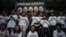 Protesters stand under a banner as they prepare to go on a hunger strike to call for &quot;true&quot; universal suffrage in Hong Kong, March 28, 2014.