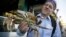 Michael Bair, of Lexington, Ky., holds an imported Dungeness crab from the Northwest at Fisherman's Wharf in San Francisco, Nov. 10, 2015. 