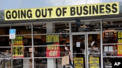 A customer leaves a Pier 1 retail store, which is going out of business, during the coronavirus pandemic in Coral Gables, Florida, Aug. 6, 2020.