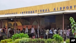 FILE - People stand in line at the Roberts International Airport in Monrovia, Liberia, Aug. 24, 2014. The 2024 Africa-Indian Ocean Aviation Week produced plans to make improvements to aviation development and safety, attendees say.