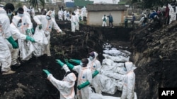 Members of the Congolese Red Cross and Civil Protection bury dozens of victims of the recent clashes in a cemetery in Goma on February 4, 2025.