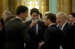 In this grab taken from video on Dec. 3, 2019, Britain's Prime Minister Boris Johnson, right, speaks during a NATO reception.