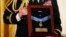 A U.S. Army officer holds a medal case displaying the Medal of Honor, the White House, April 11, 2013. 