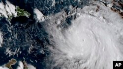 GOES East satellite image provided by NASA taken at 20:30 UTC, shows the eye of Hurricane Maria as it nears Dominica, Sept. 18, 2017.
