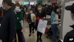 FILE - Parents and children at a children's hospital in Beijing on Oct. 30, 2023, during a surge in respiratory illnesses across China. 