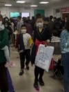 FILE - Parents and children at a children's hospital in Beijing on Oct. 30, 2023, during a surge in respiratory illnesses across China. 