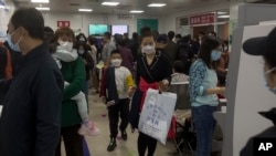 Parents and children at a children's hospital in Beijing on Oct. 30, 2023, during a surge in respiratory illnesses across China. 