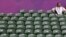 A spectator sits amid empty seats at the All England Lawn Tennis Club during a match at the London 2012 Olympics Games July 28, 2012. 