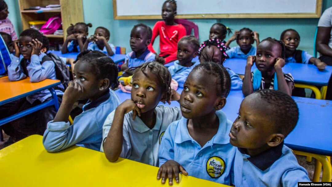 Refugee children at the African Hope School watch cartoons before they go home, Sept. 16, 2017, in Cairo, Egypt.