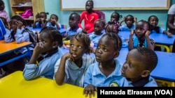 Refugee children at the African Hope School watch cartoons before they go home, Sept. 16, 2017, in Cairo, Egypt.